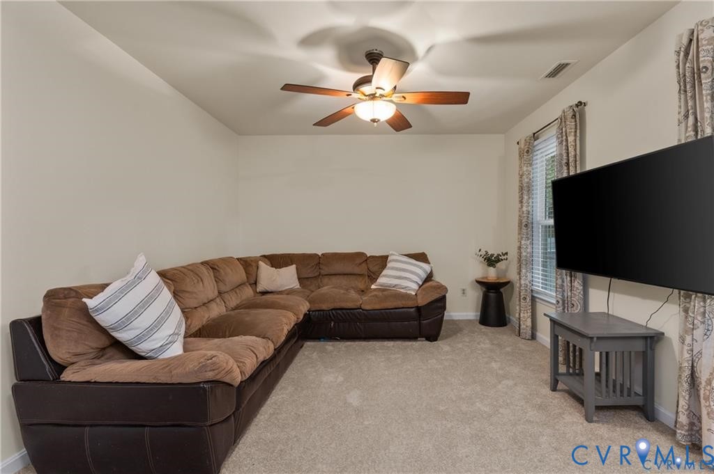13501 Buck Rub Drive Midlothian, VA 23112 - Photo 8 of 35 a living room with furniture and a flat screen tv
