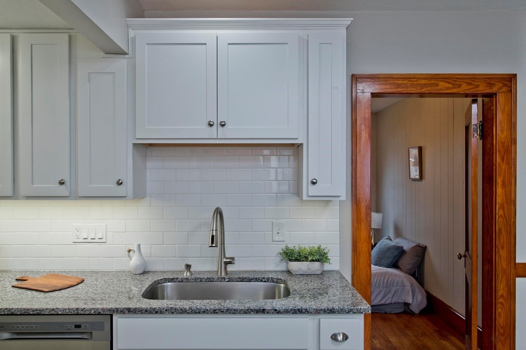 29 Acton Street Springfield, MA 01151 - Photo 11 of 39 a kitchen with granite countertop stainless steel appliances white cabinets and a sink