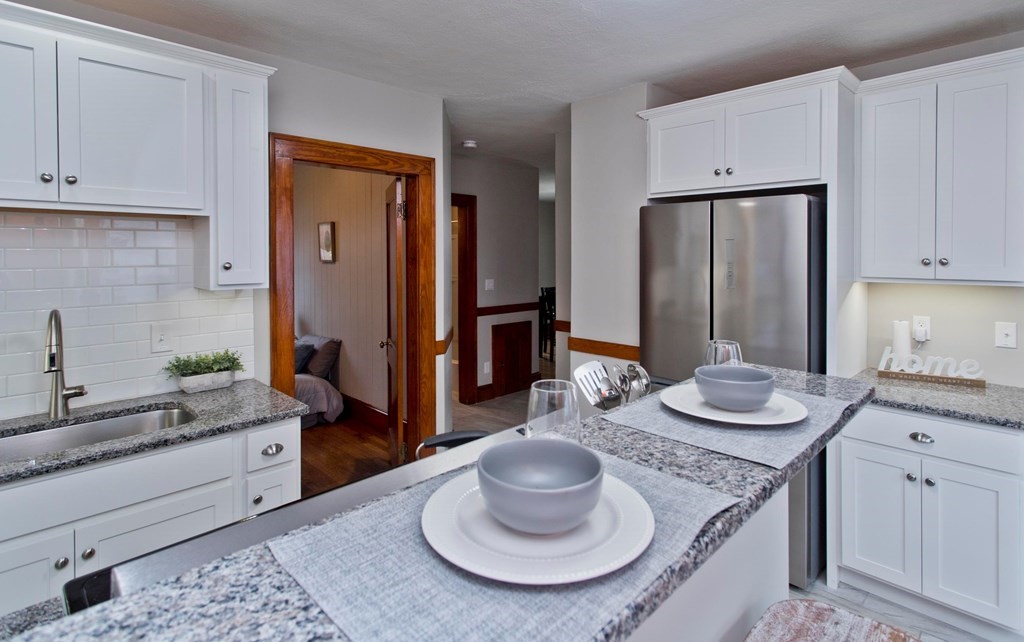 29 Acton Street Springfield, MA 01151 - Photo 12 of 39 a kitchen with stainless steel appliances granite countertop a sink and a refrigerator