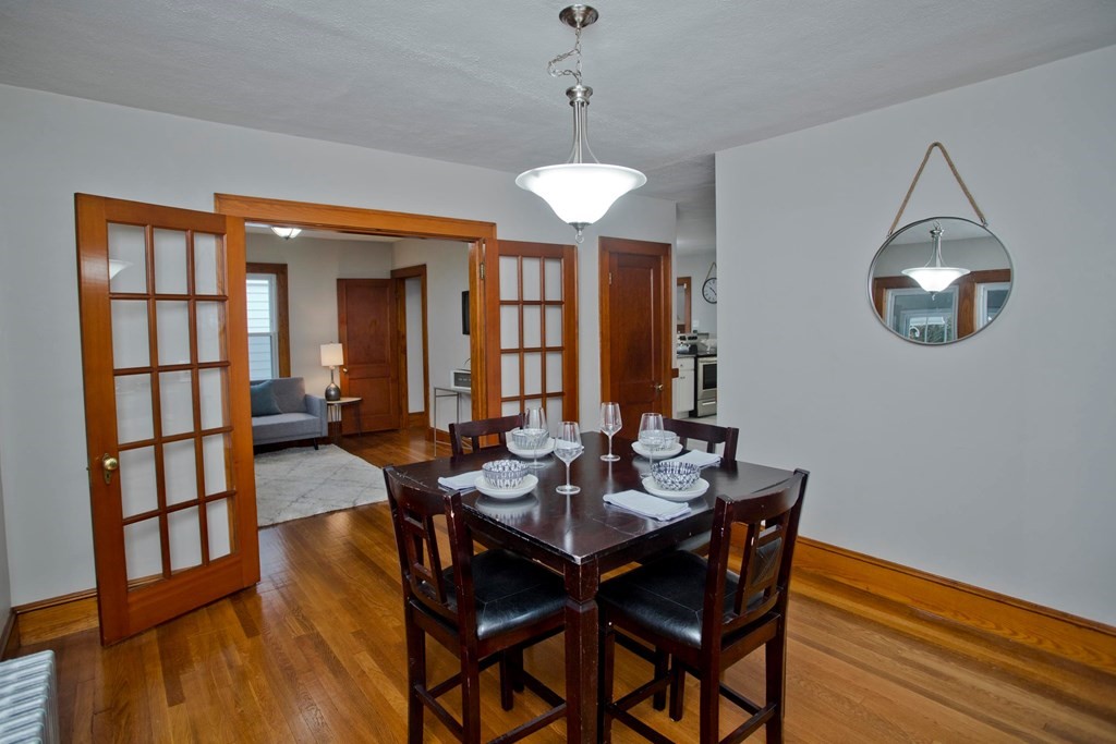 29 Acton Street Springfield, MA 01151 - Photo 14 of 39 a dining room with furniture a chandelier and wooden floor