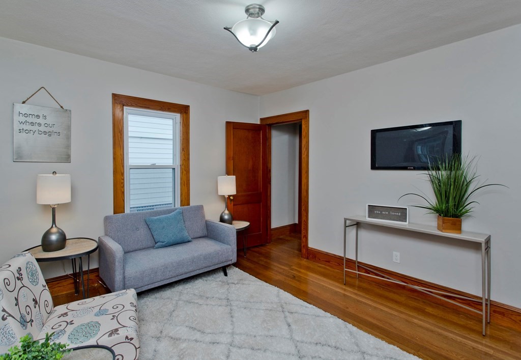29 Acton Street Springfield, MA 01151 - Photo 17 of 39 a living room with furniture and a flat screen tv