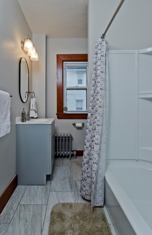 29 Acton Street Springfield, MA 01151 - Photo 22 of 39 a bathroom with a bathtub a sink and a mirror