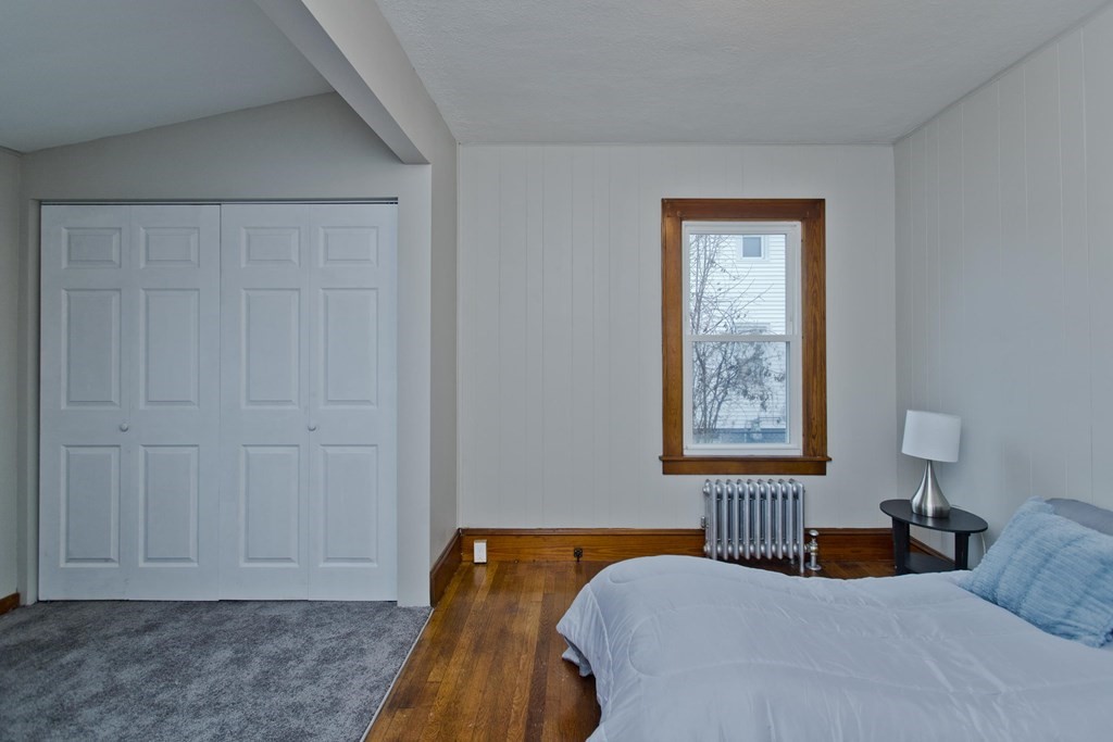 29 Acton Street Springfield, MA 01151 - Photo 26 of 39 a bedroom with a bed and a window