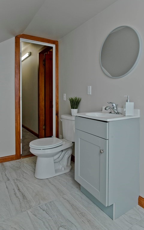 29 Acton Street Springfield, MA 01151 - Photo 29 of 39 a bathroom with a sink mirror and toilet
