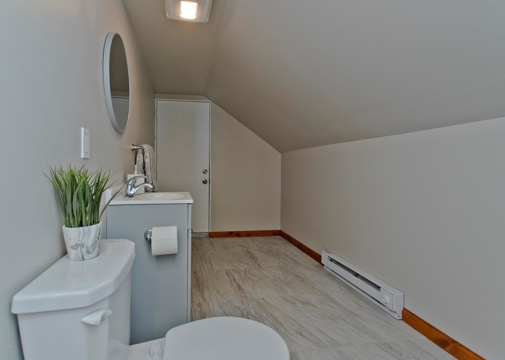 29 Acton Street Springfield, MA 01151 - Photo 30 of 39 a bathroom with a toilet a sink and mirror