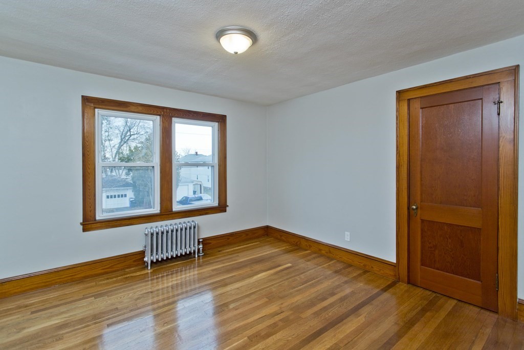 29 Acton Street Springfield, MA 01151 - Photo 31 of 39 an empty room with wooden floor and windows