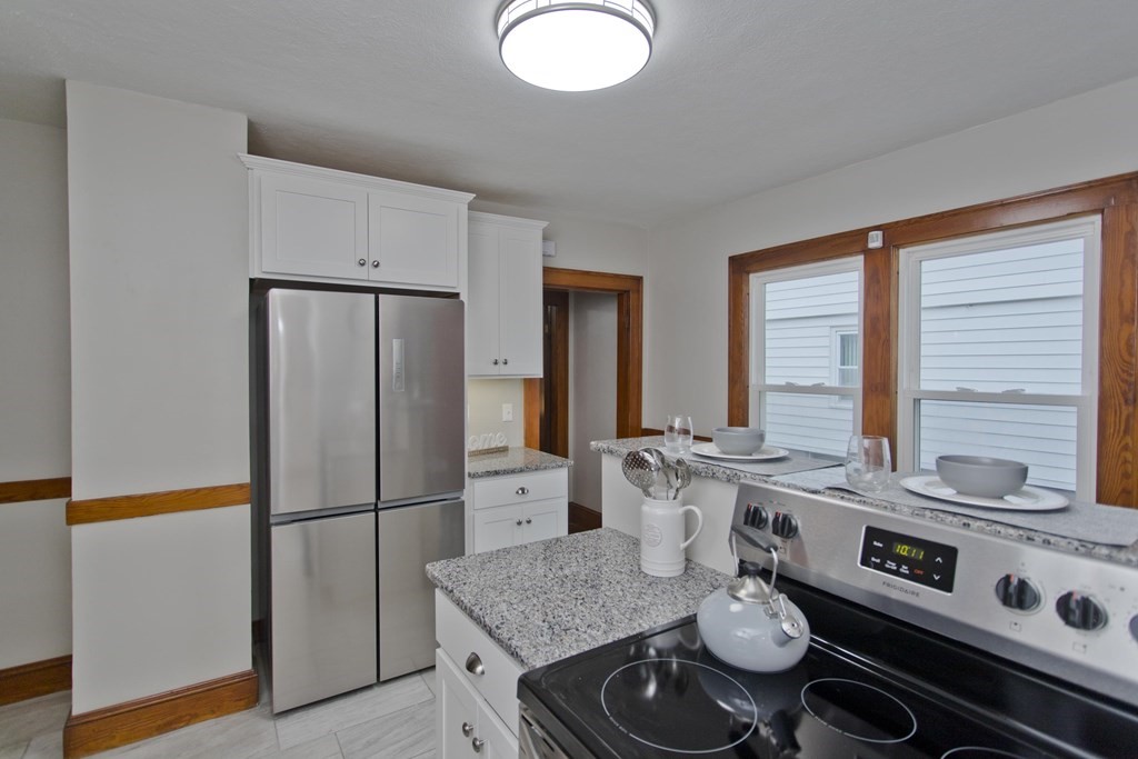 29 Acton Street Springfield, MA 01151 - Photo 5 of 39 a kitchen with stainless steel appliances granite countertop a stove and a refrigerator
