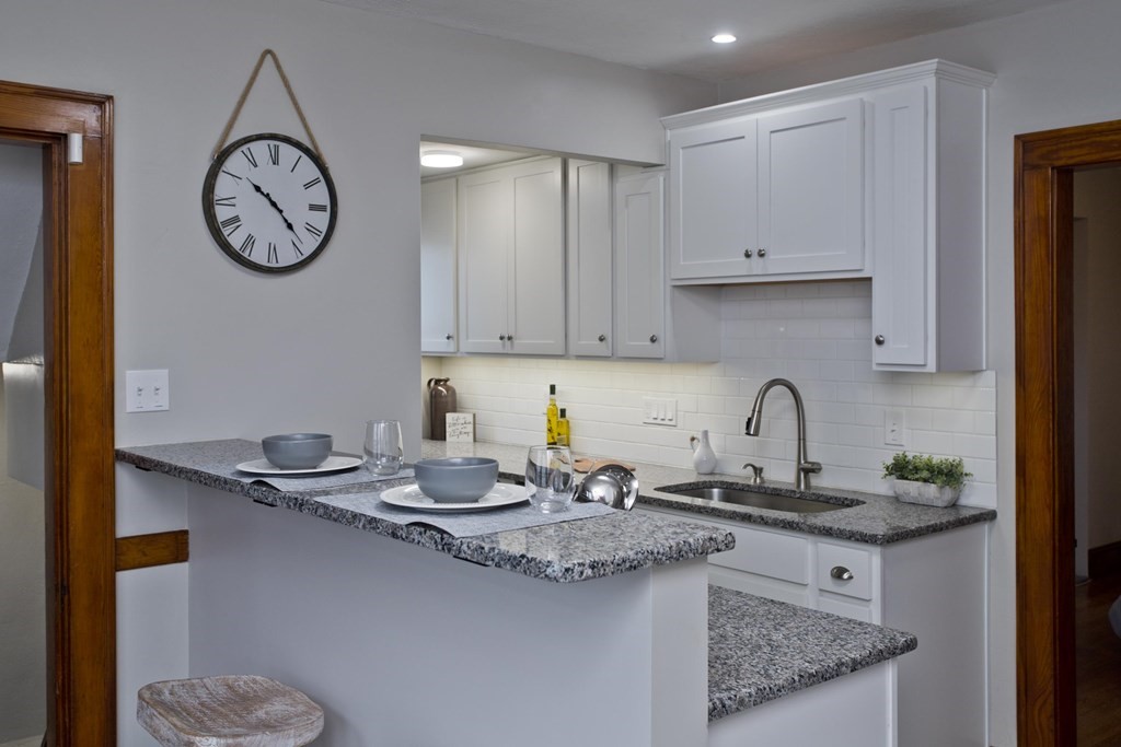 29 Acton Street Springfield, MA 01151 - Photo 8 of 39 a kitchen with stainless steel appliances granite countertop a sink a stove and cabinets