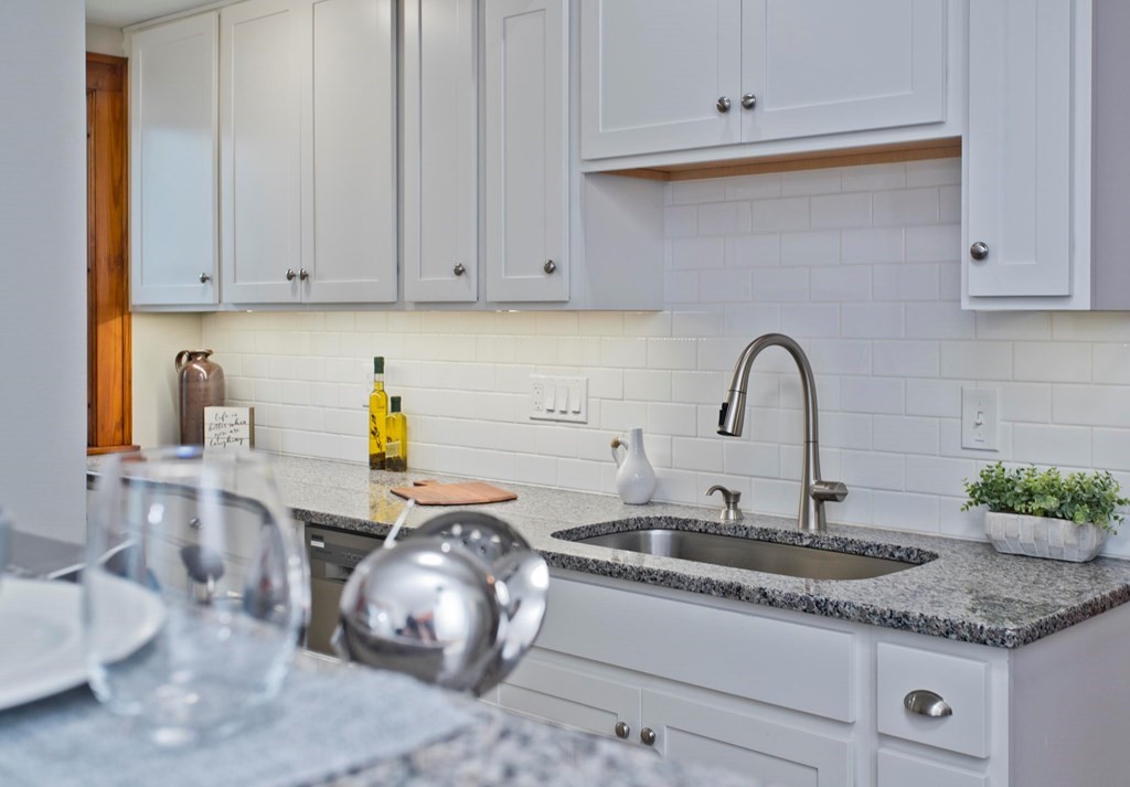 29 Acton Street Springfield, MA 01151 - Photo 9 of 39 a kitchen with granite countertop a sink and a stove