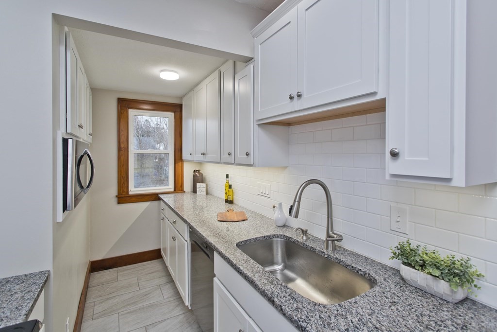 29 Acton Street Springfield, MA 01151 - Photo 10 of 39 a kitchen with a sink and a refrigerator