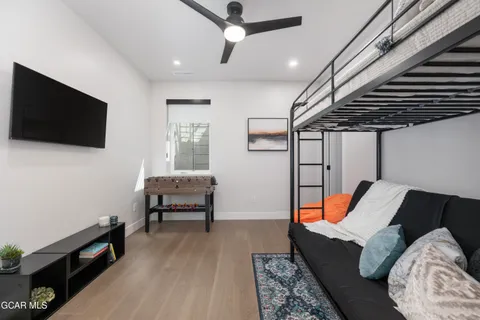 a bedroom with furniture and wooden floor