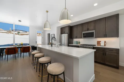 a kitchen with sink cabinets and dining table
