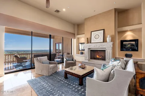 a living room with furniture a rug and a fireplace