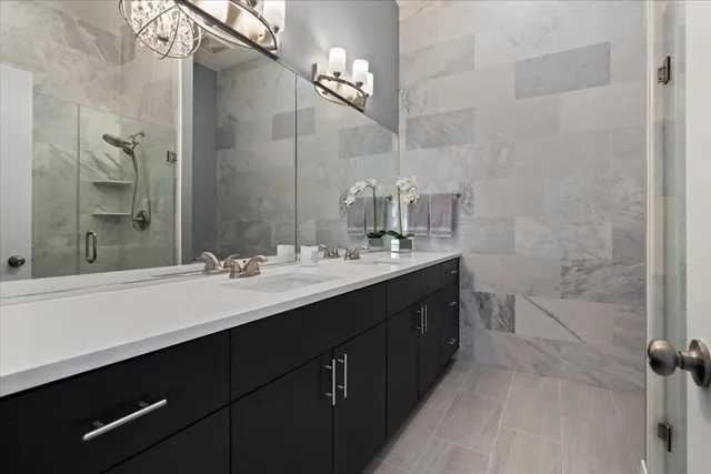 a bathroom with a double vanity sink a toilet and a mirror