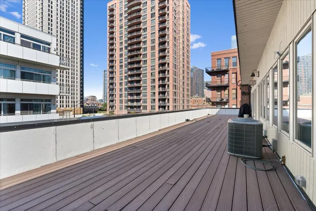 a view of balcony with wooden floor and fence