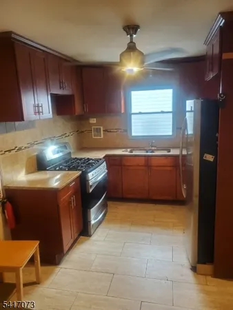 a kitchen with stainless steel appliances granite countertop a sink counter space and cabinets