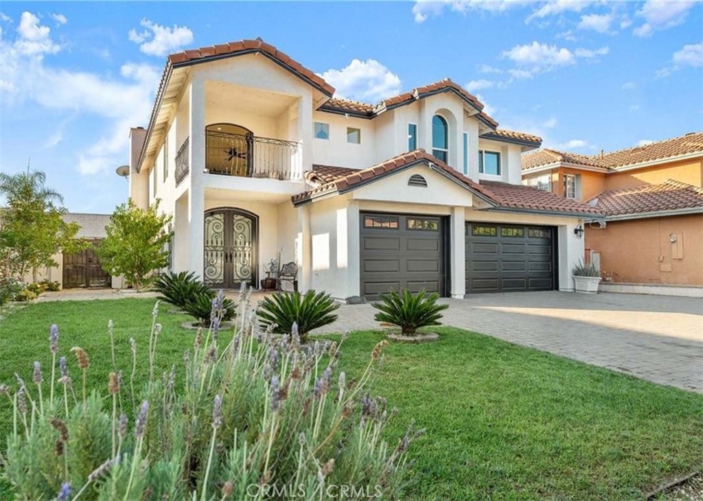 11179 Summerside Lane Rancho Cucamonga, CA 91737 - Photo 2 of 46 a front view of a house with a yard and garage