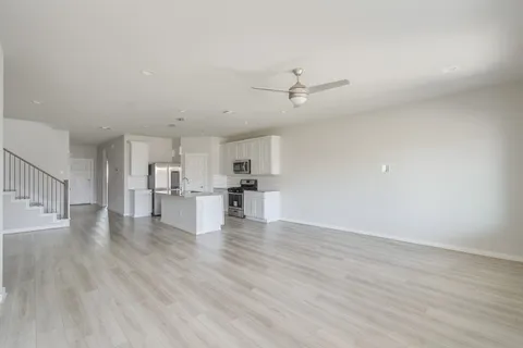 a view of kitchen with furniture and wooden floor