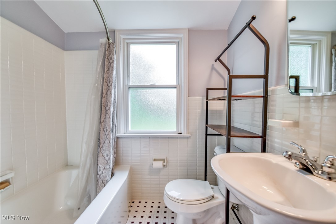 8115 Stockbridge Road Mentor, OH 44060 - Photo 23 of 46 Full bath featuring tile walls, plenty of natural light, shower / bath combo, and wainscoting