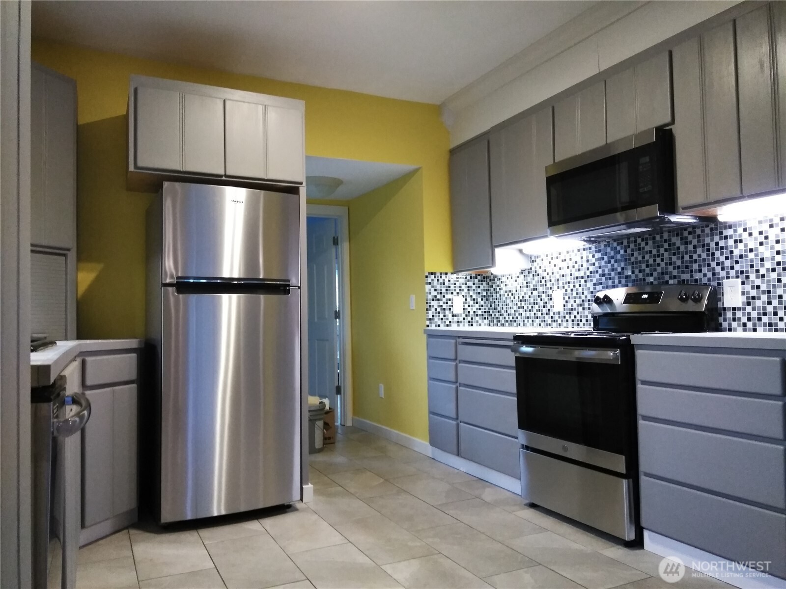 211 Garfield Street Hoquiam, WA 98550 - Photo 11 of 26 a kitchen with stainless steel appliances granite countertop a refrigerator and a stove