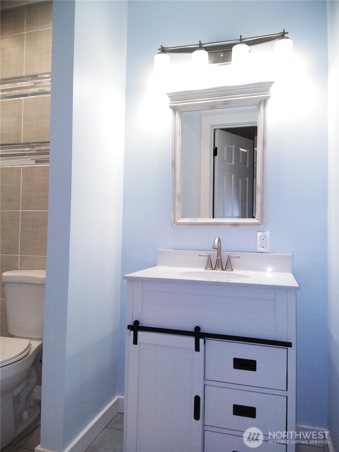211 Garfield Street Hoquiam, WA 98550 - Photo 17 of 26 a bathroom with a toilet sink and mirror