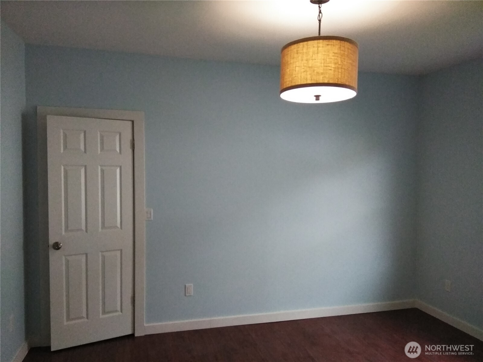 211 Garfield Street Hoquiam, WA 98550 - Photo 8 of 26 an empty room with wooden floor and windows