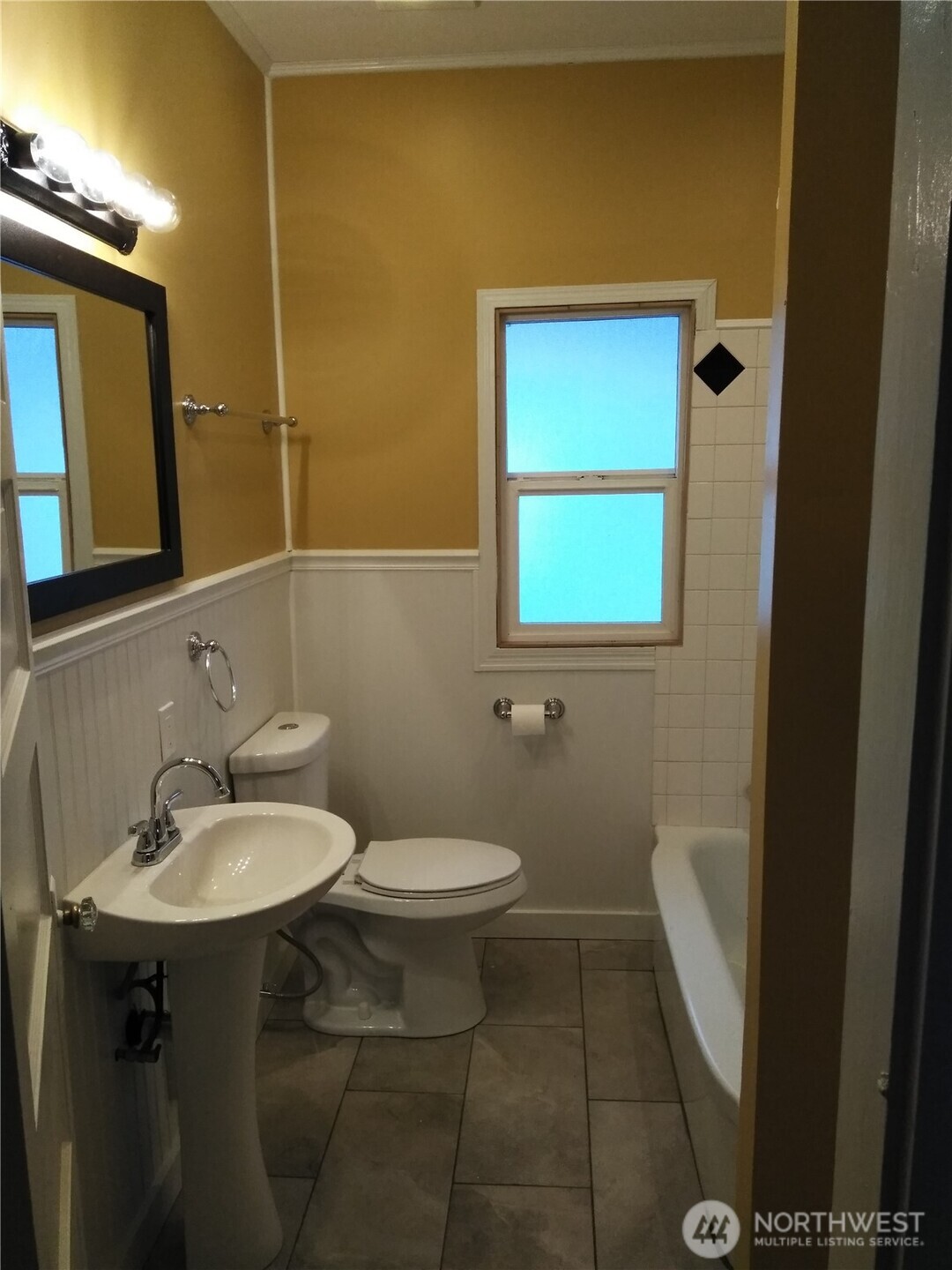 211 Garfield Street Hoquiam, WA 98550 - Photo 9 of 26 a bathroom with a sink a toilet and mirror