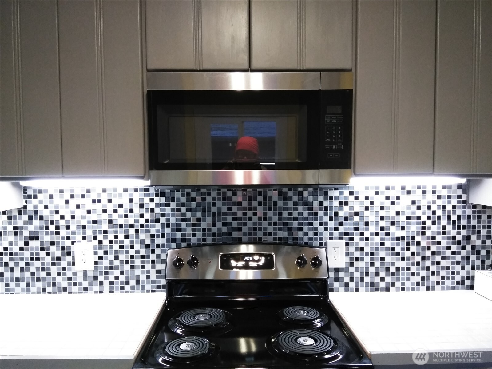 211 Garfield Street Hoquiam, WA 98550 - Photo 10 of 26 a kitchen with a sink a stove and wooden cabinets