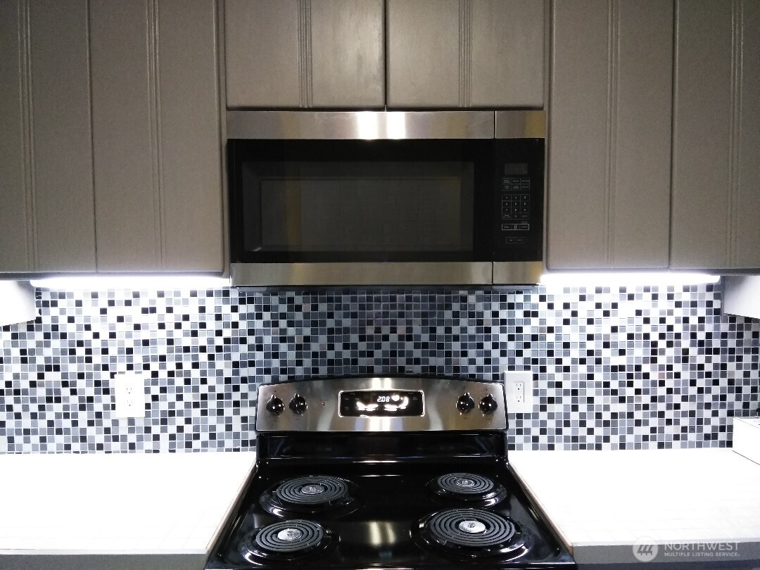 211 Garfield Street Hoquiam, WA 98550 - Photo 10 of 26 a kitchen with a sink a stove and cabinets