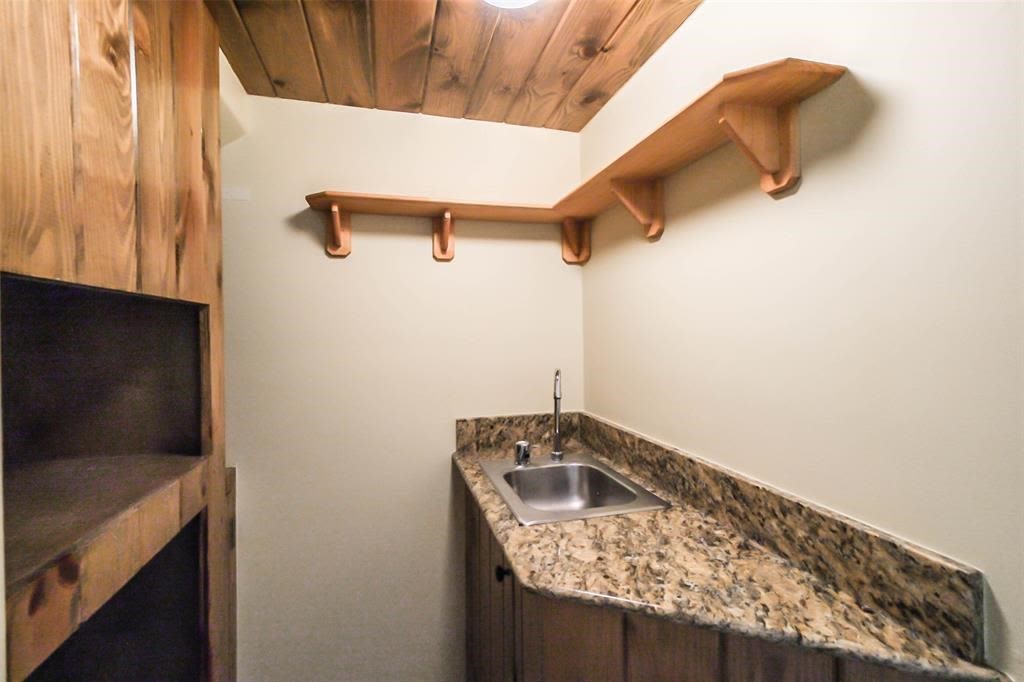 706 Allston Street, Unit B Houston, TX 77007 - Photo 9 of 33 a bathroom with a granite countertop sink and washing machine