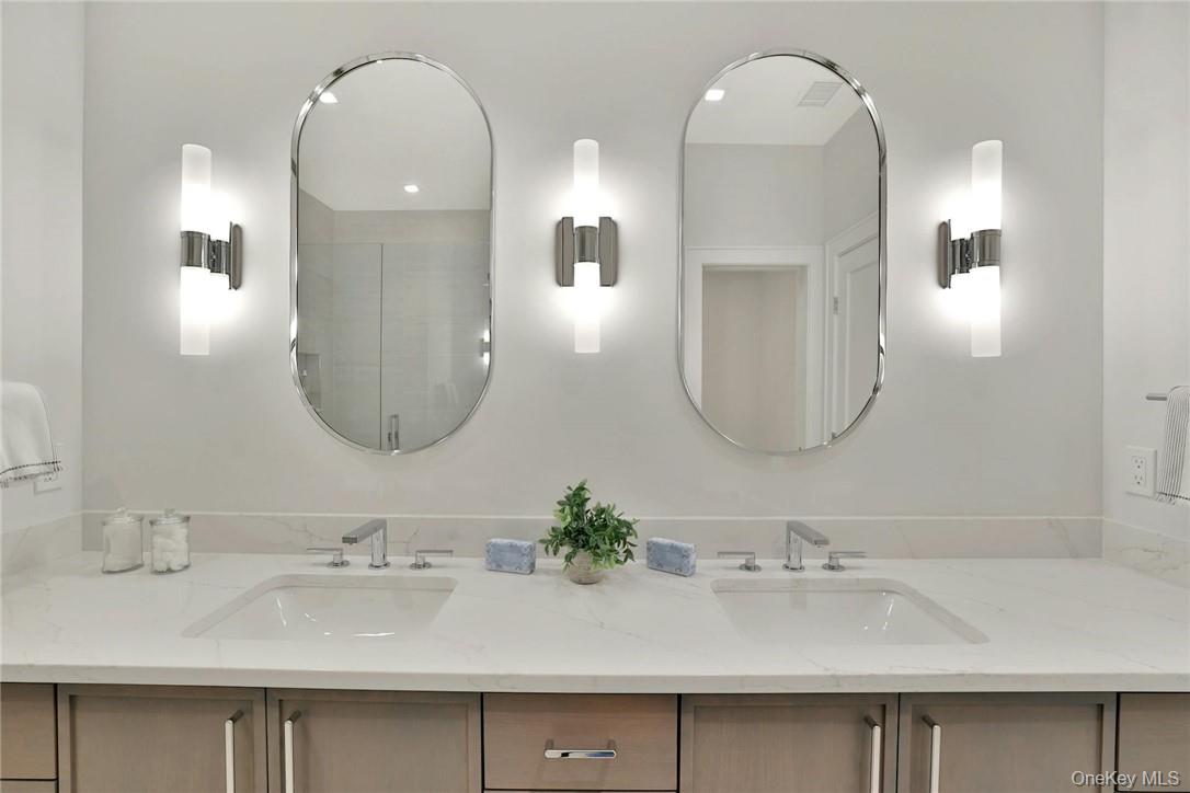 162 Bedford Road, Unit 16 Armonk, NY 10504 - Photo 13 of 37 a bathroom with double vanity sinks and a mirror