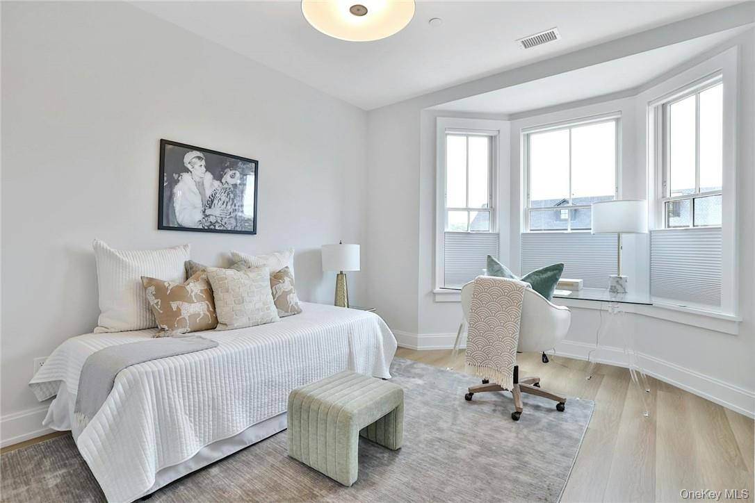 162 Bedford Road, Unit 16 Armonk, NY 10504 - Photo 17 of 37 a bed room with a bed and a chair