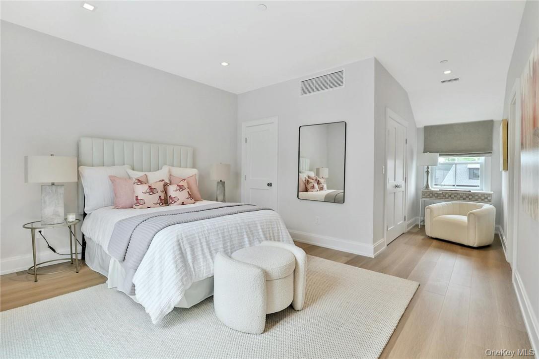 162 Bedford Road, Unit 16 Armonk, NY 10504 - Photo 20 of 37 a spacious bedroom with a bed and couch