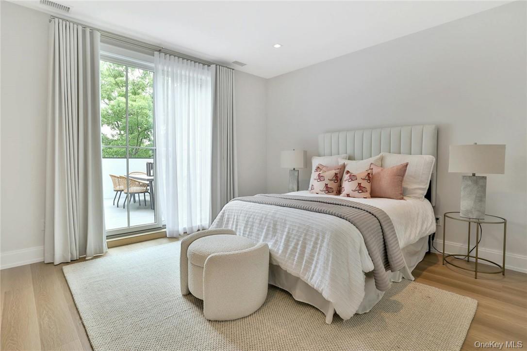 162 Bedford Road, Unit 16 Armonk, NY 10504 - Photo 21 of 37 a bedroom with a bed and a large window