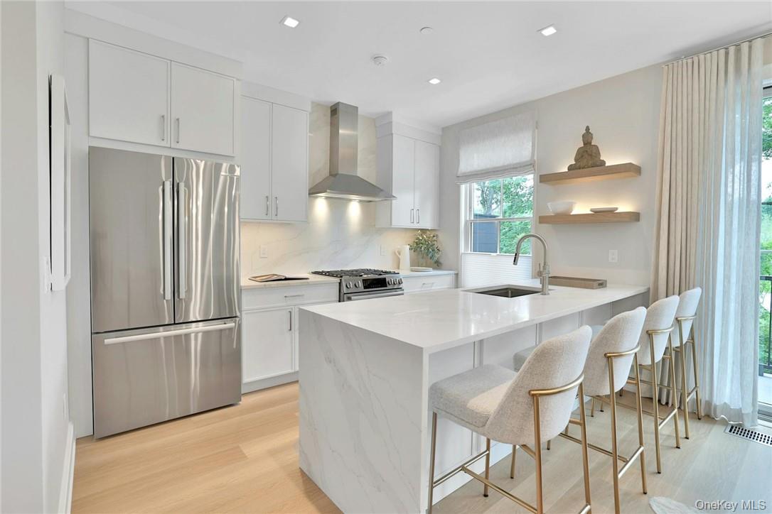 162 Bedford Road, Unit 16 Armonk, NY 10504 - Photo 6 of 37 a kitchen with kitchen island a appliances a sink and cabinets