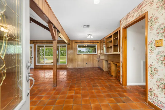 a big room with wooden floor and furniture