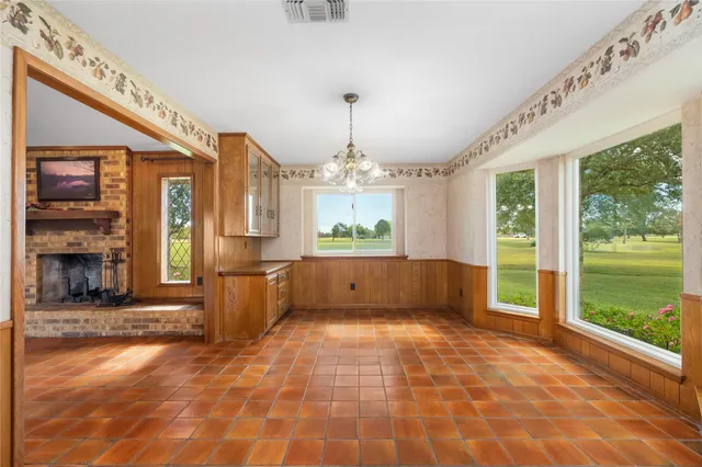a large kitchen with a lot of counter space and a wooden floor