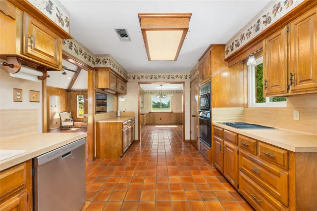 a kitchen with stainless steel appliances granite countertop a stove a sink and a refrigerator