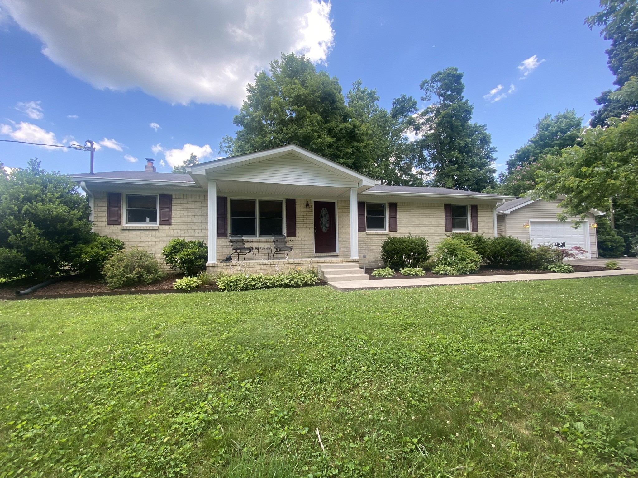818 Dale Ridge Road Dowelltown, TN 37059 - Photo 1 of 24 a front view of a house with a yard and potted plants