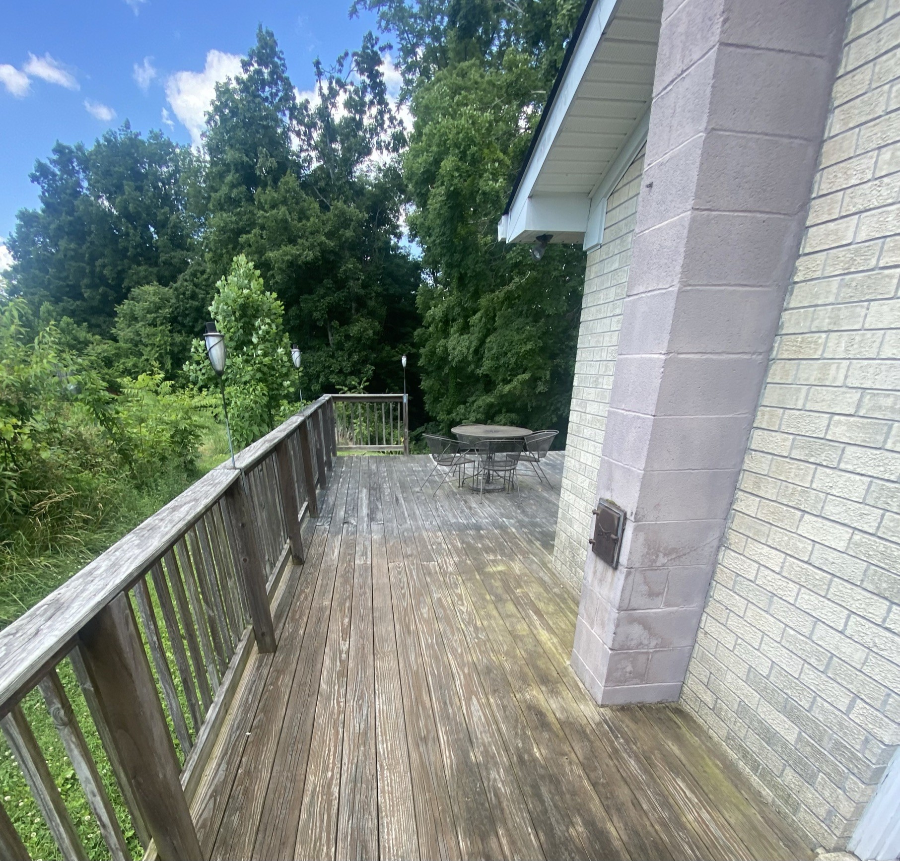 818 Dale Ridge Road Dowelltown, TN 37059 - Photo 19 of 24 a balcony with wooden floor and trees in the back
