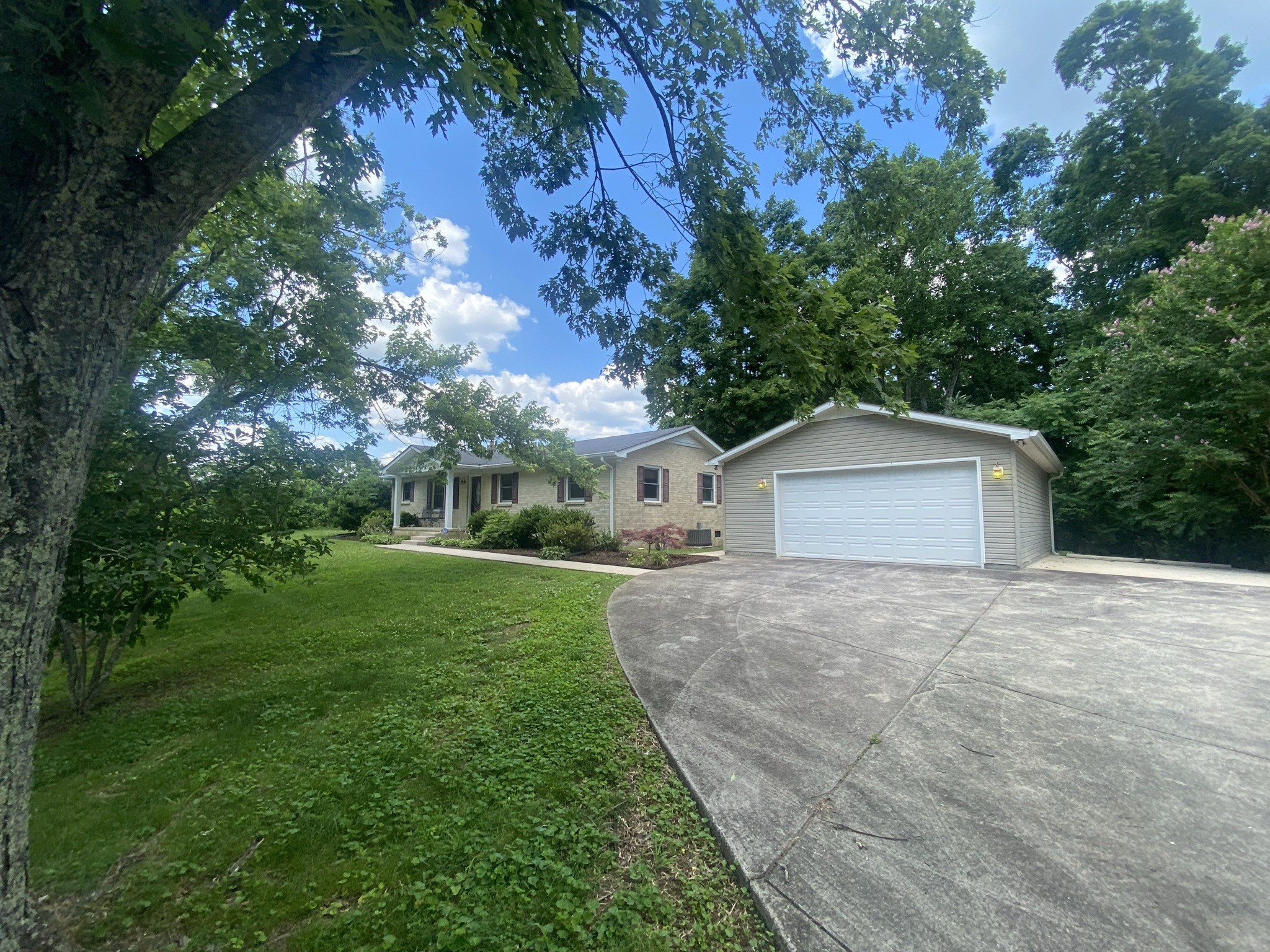 818 Dale Ridge Road Dowelltown, TN 37059 - Photo 3 of 24 a front view of a house with a yard and garage