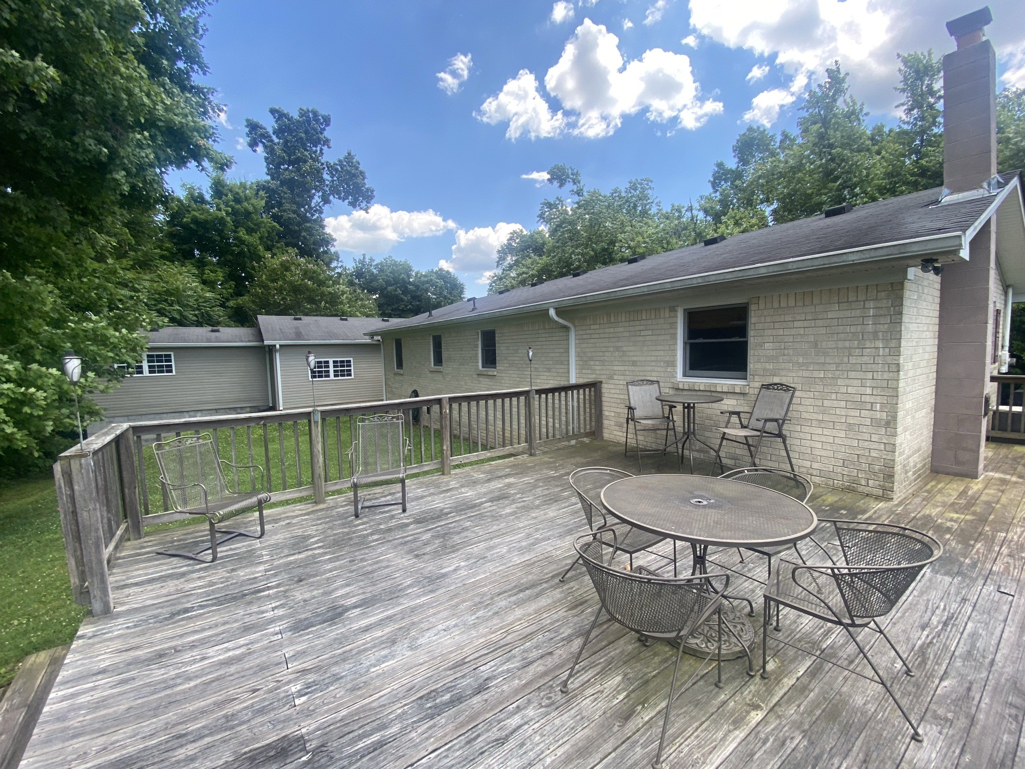 818 Dale Ridge Road Dowelltown, TN 37059 - Photo 21 of 24 a view of a patio with table and chairs with wooden floor and fence