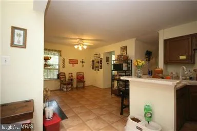 a kitchen with a sink and chairs