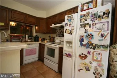 a kitchen with stainless steel appliances a refrigerator and a stove top oven