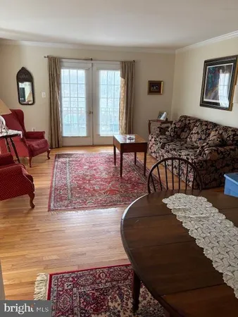 a dining room with furniture a rug a rug and a chandelier