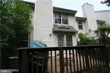 a view of a house with a small yard and wooden fence