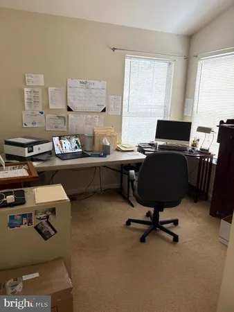 a bedroom with a bed and a lamp on dresser