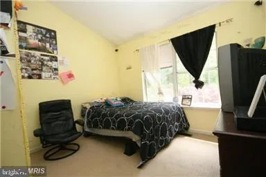 a bedroom with a bed and a flat tv screen