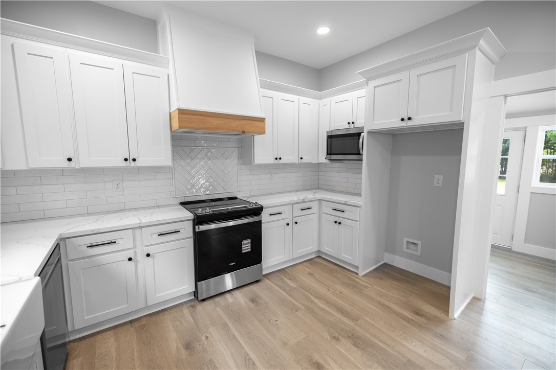 2817 Broadway Lake Road Anderson, SC 29621 - Photo 25 of 41 A well-appointed kitchen showcases white cabinetry, pristine countertops, and wood flooring.