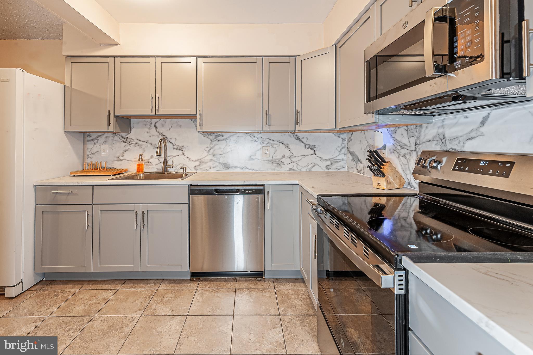 41 Noble Road Sicklerville, NJ 08081 - Photo 5 of 18 a kitchen with stainless steel appliances a sink and a stove